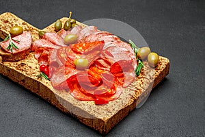 Cold meat plate with salami and chorizo sausage on cork wood board