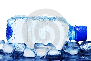 Cold mineral water bottle with ice cubes