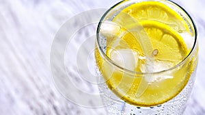 Cold mineral water with ice and lemon.