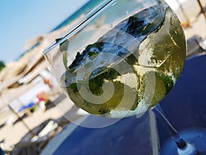 Cold mojito cocktail on beach and sea view