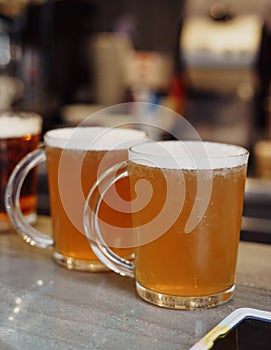 cold mugs of beer on a terrace table