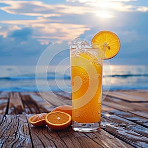 Cold orange juice with ice on a wooden balcony by sea