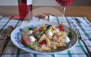Cold pasta with mini mozzarella, cherry tomato, basil leaves, black olives and rosÃ© wine Cerasuoloe