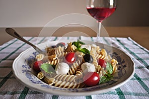 Cold pasta with mini mozzarella, cherry tomato, basil leaves, black olives and rosÃ© wine Cerasuoloe