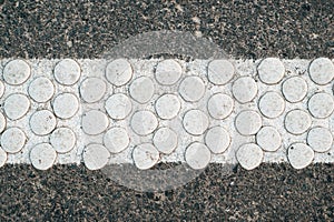Cold plastic structured stripes with dot pattern for road surface marking as background