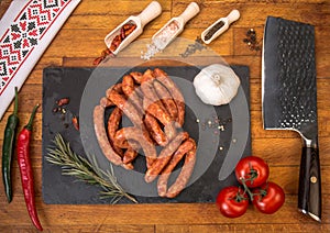 Cold platter of sausages on wooden table