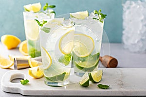 Cold refreshing mojito with lemon and lime and mint in tall glasses