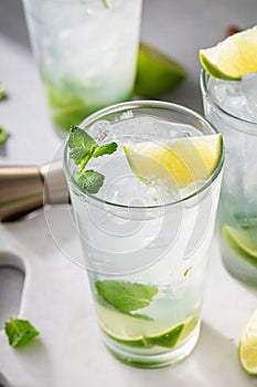 Cold refreshing mojito with lime and mint in tall glasses