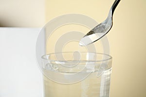 Cold relief powder dissolving in water, closeup