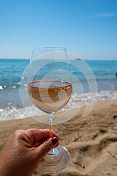 Cold rose wine from Provence served outdoor on white sandy beach Plage de Pampelonne near Saint-Tropez, France