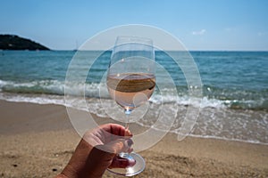 Cold rose wine from Provence served outdoor on white sandy beach Plage de Pampelonne near Saint-Tropez, France