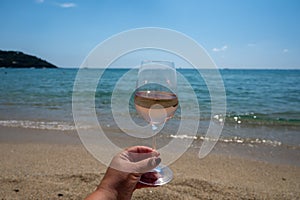Cold rose wine from Provence served outdoor on white sandy beach Plage de Pampelonne near Saint-Tropez, France