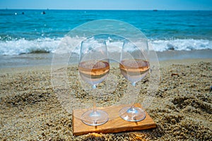 Cold rose wine from Provence served outdoor on white sandy beach Plage de Pampelonne near Saint-Tropez, France