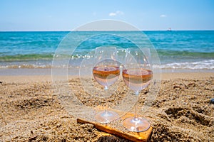 Cold rose wine from Provence served outdoor on white sandy beach Plage de Pampelonne near Saint-Tropez, France