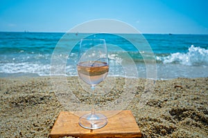 Cold rose wine from Provence served outdoor on white sandy beach Plage de Pampelonne near Saint-Tropez, France