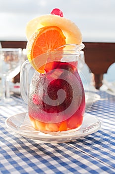 Cold sangria in the glass jug with condensate