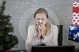 Cold secretary blows her nose into a handkerchief