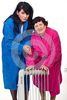 Cold shivering women with radiator heat photo