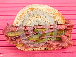 Cold Sliced Salt Beef or Pastrami With Gherkins in a Ciabatta Bread Roll or