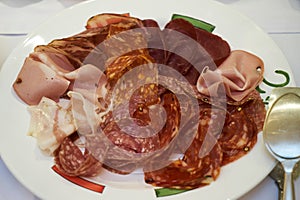 Cold smoked meat plate with sliced pork, prosciutto, salami, ham