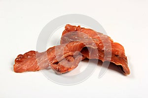 Cold smoked salmon strips on a white background