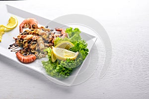 Cold snacks. Seafood, shrimp,  On a wooden background. Top view. Free space