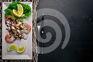 Cold snacks. Seafood, shrimp,  On a wooden background.