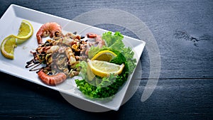 Cold snacks. Seafood, shrimp, mussels, On a wooden background.