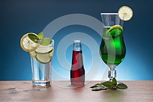Cold soda with lemon and mint, red italian aperitif, and mint l