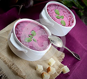 Cold soup fresh beet with cream, vintage spoon, napkin, crackers