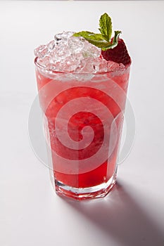 Cold straw red drink with berry and mint leaf.