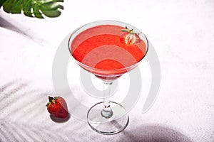 Cold strawberry margarita or daiquiri cocktail with lime and rum