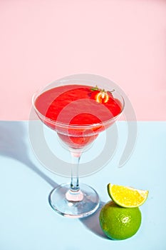 Cold strawberry margarita or daiquiri cocktail with lime and rum