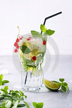 Cold summer drink, Sangria, Lemonade or Mojito with fresh Red currant lemon , lime mint leaves