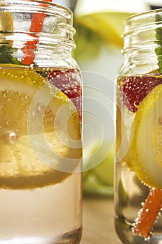 Cold summer refreshments in glass jar with lemon