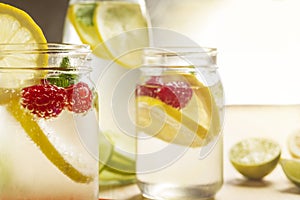 Cold summer soda with lemon and berries in glass