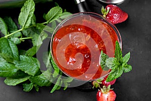 Cold summer strawberry cocktail mojito, margarita, daiquiri in a martini glass on dark background, close up