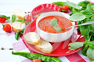 Cold summer tomato dish. Gaspacho soup with toast.