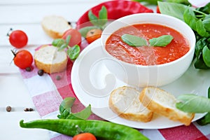 Cold summer tomato dish. Gaspacho soup with toast.