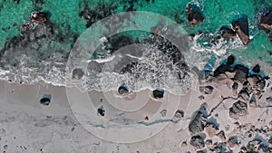 Cold transparent waves roll on coastline sand beach aerial