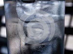 Cold water glass with ice cubes, Water drops, Close up & Macro shot, Selective focus, Healthy Drink concept