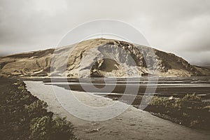 Cold water in Iceland. Stream in rocky mountains and lake side.