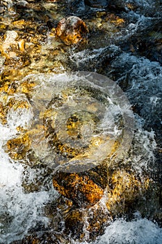 Cold Water Rushes Over Rocks Below