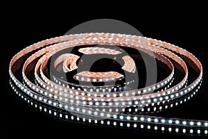 Cold white LED strip on reel with black background