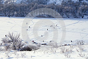 Cold winter. Frozen river. Peoples on ice.