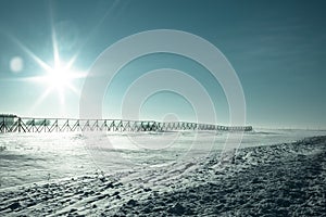 Cold winter landscape. A fence to protect the road from snow.