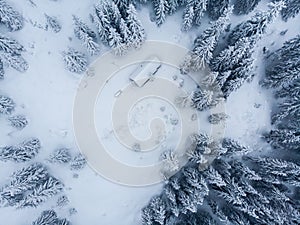 Chladné zimní ráno v horském lese se zasněženými jedlemi. Tatry, Slovensko. Letecký pohled. Kabina sama ve sněhovém lese.