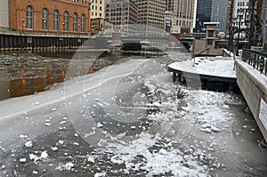 Cold winter scene with ice floating in river with icebergs and snow