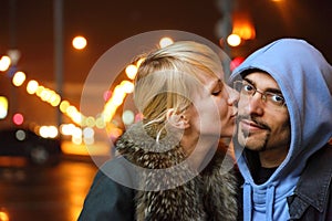 Coldly fall city. woman is kissing her man