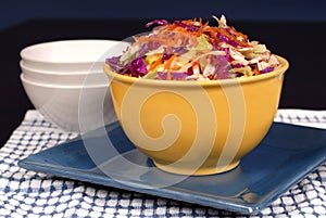 Cole slaw with carrot in a yel photo